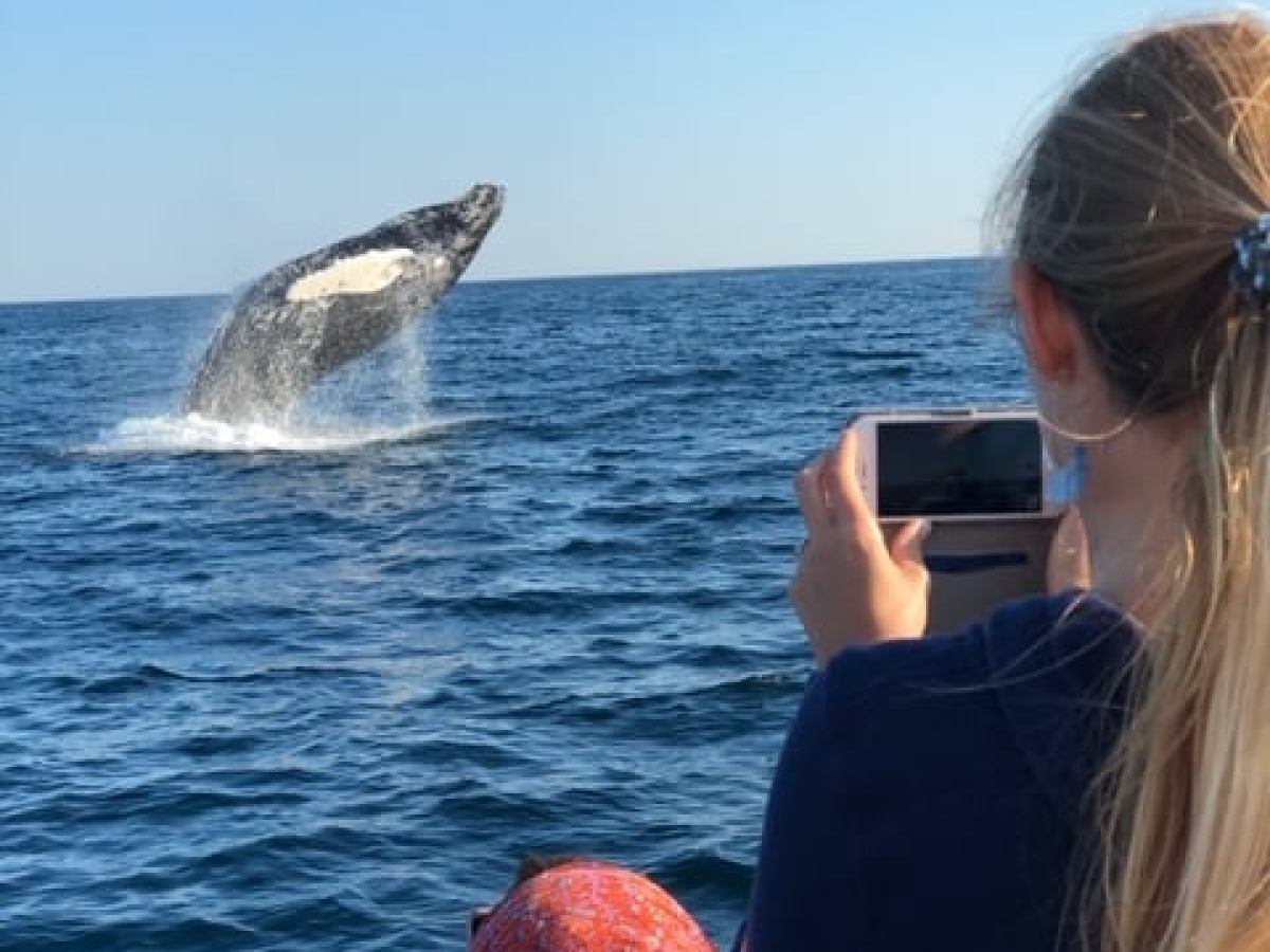 a woman holding a fish in the water